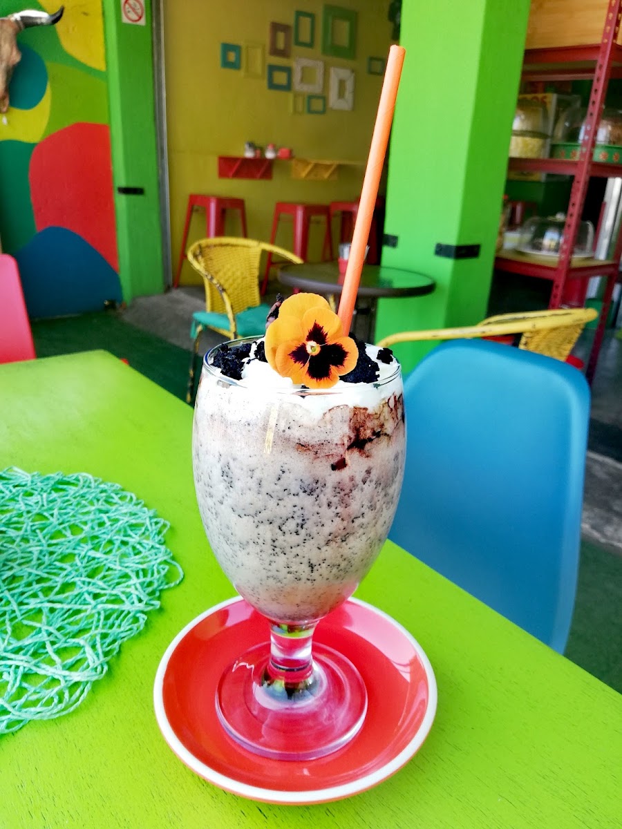 A cookies-and-cream milkshake topped with an orange pansy